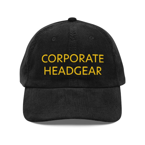 Corporate Headgear black corduroy cap with yellow embroidered text and adjustable gold buckle strap.